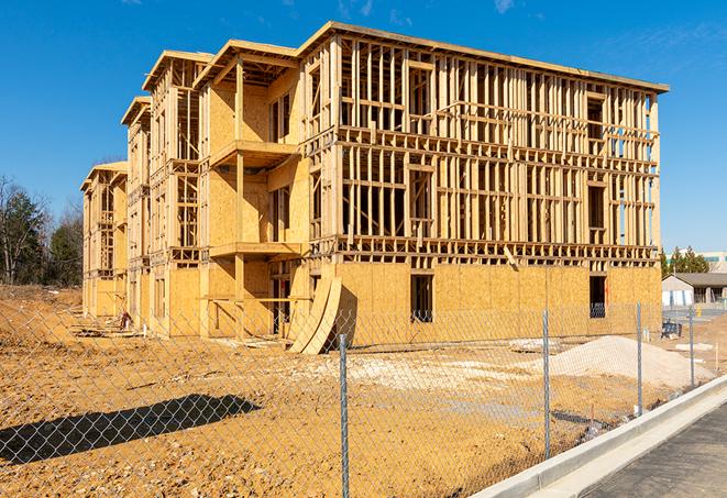 a close-up of temporary chain link fences enclosing a construction site, signaling progress in the project's development in Wickliffe